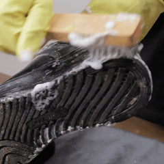 Brushing foam off a sneaker sole with the Scrubsy brush