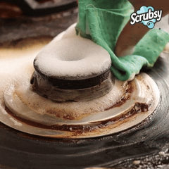 Wiping Scrubsy foam and loosened grease off a gas stove burner